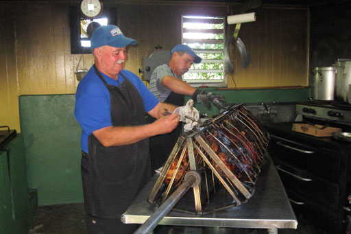 Men cooking the lechon at La Catumba